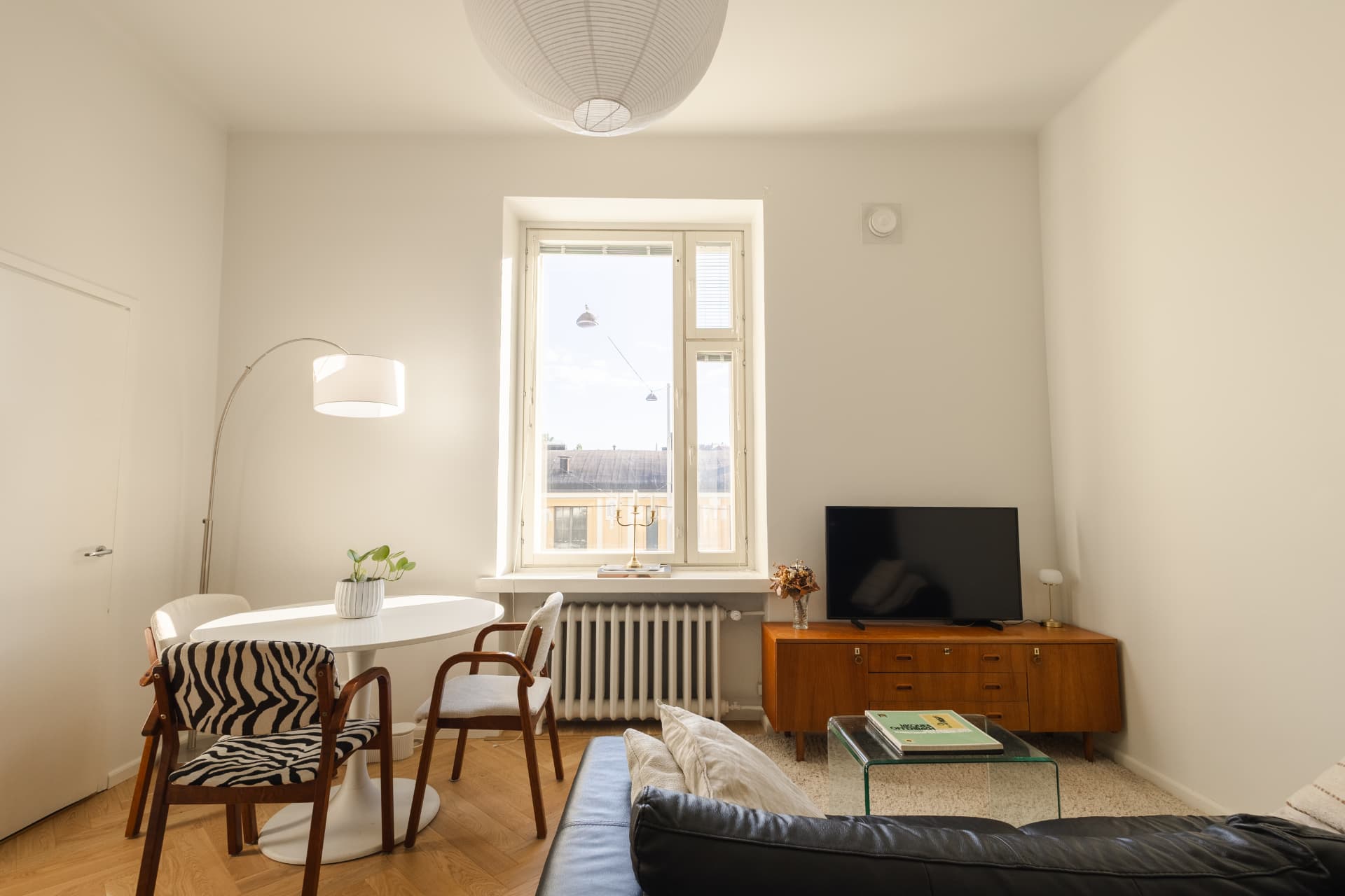 Sunlit living and dining room in a Helsinki apartment