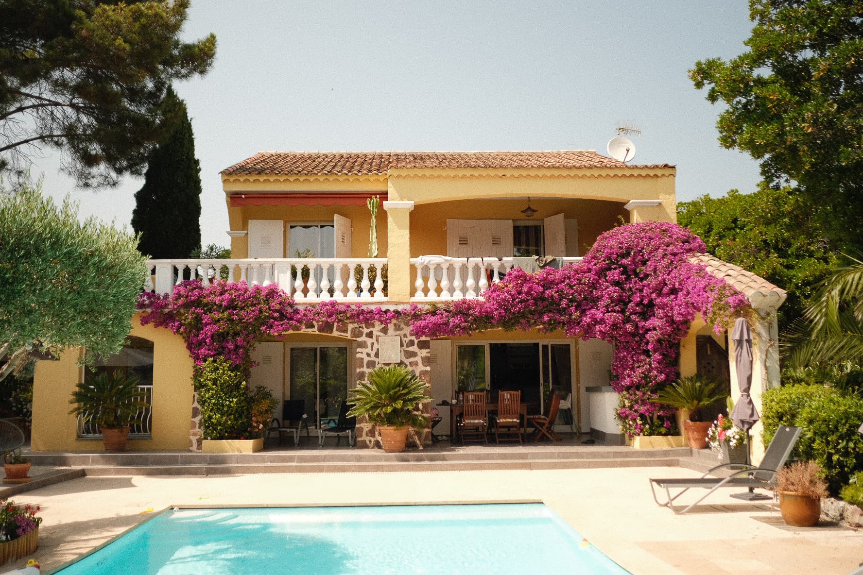 Holiday villa with a pool and flowering bougainvillea