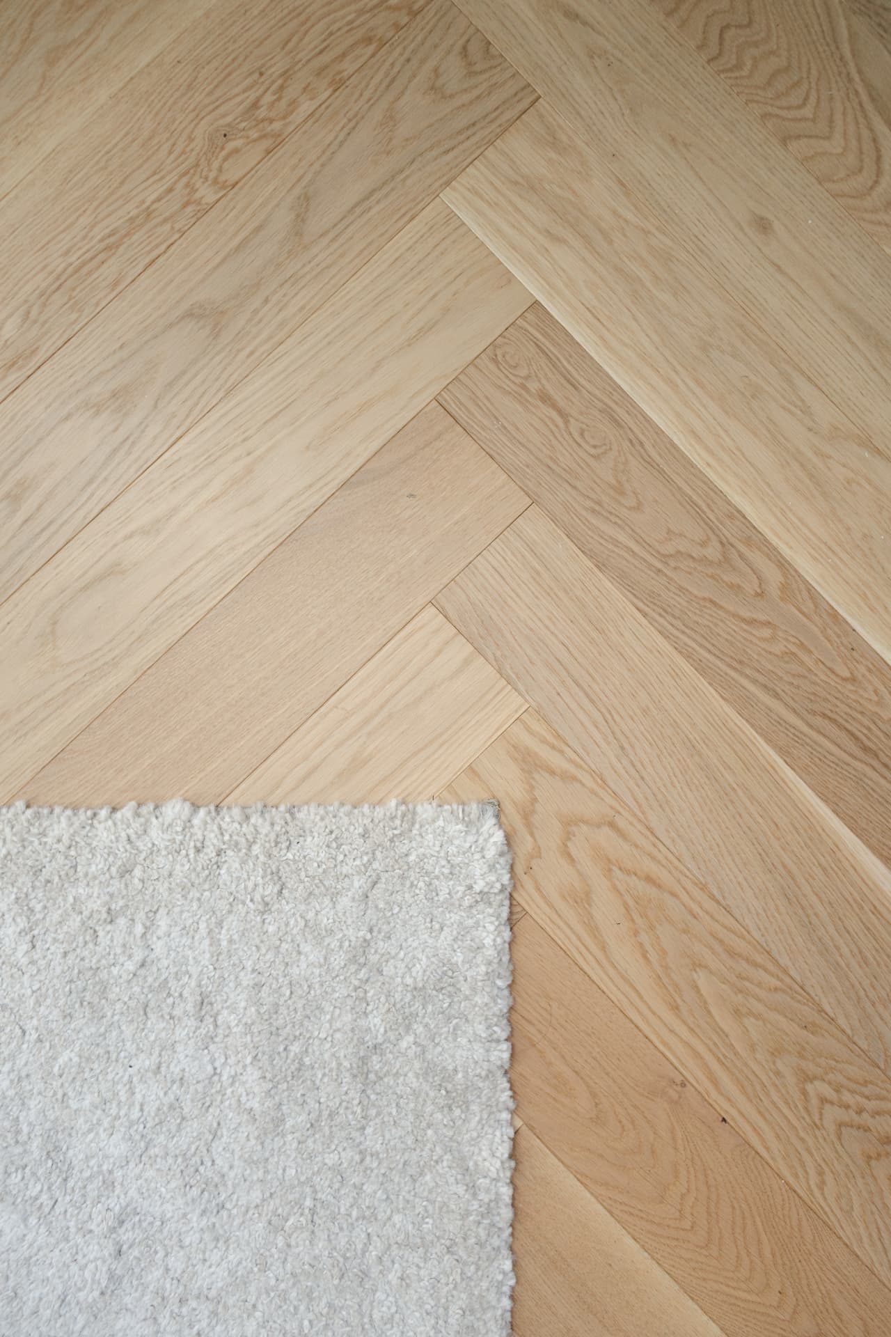 Herringbone oak floor and soft wool rug detail